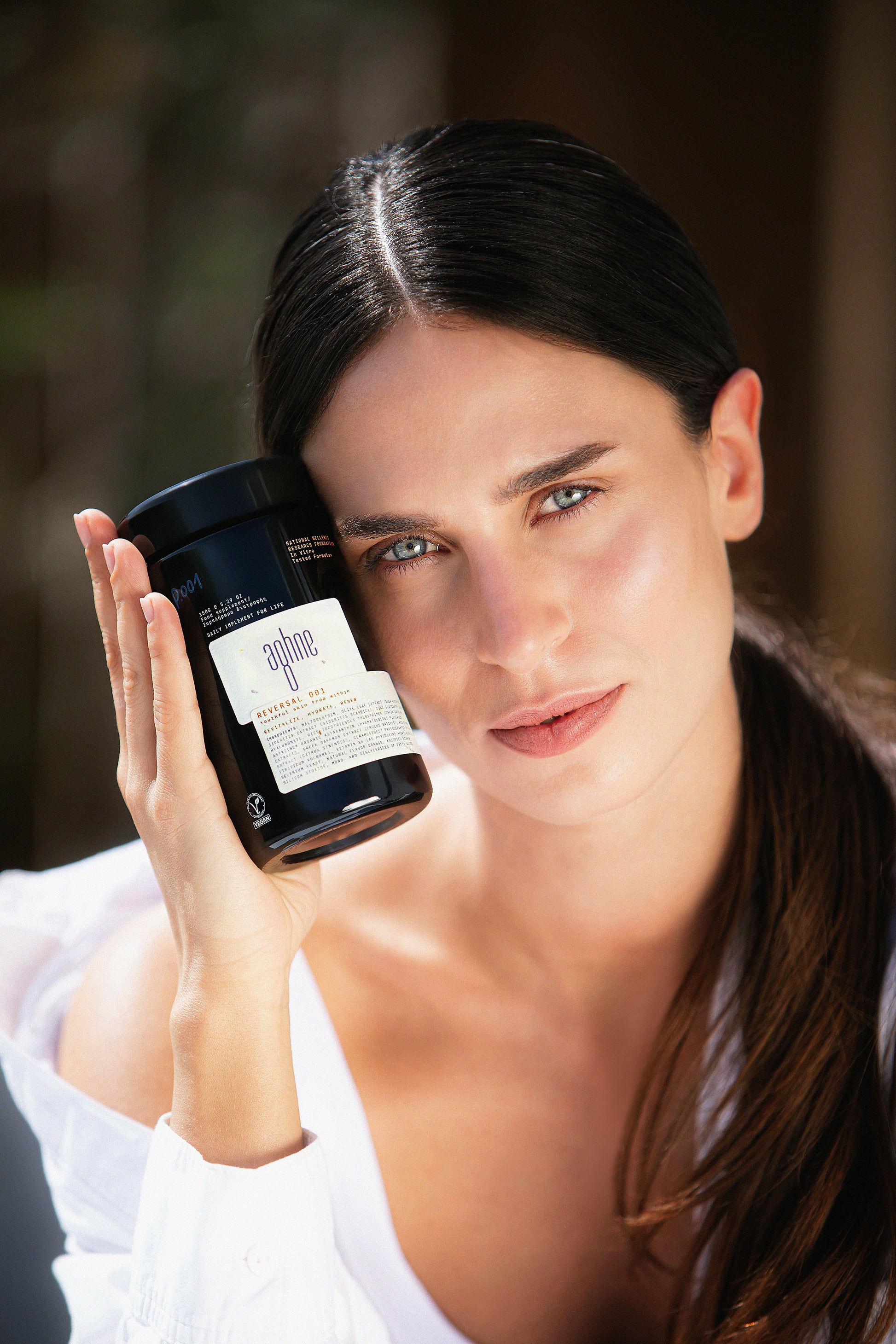 Woman holding a jar of reversal 001 by aghne with a blurred background