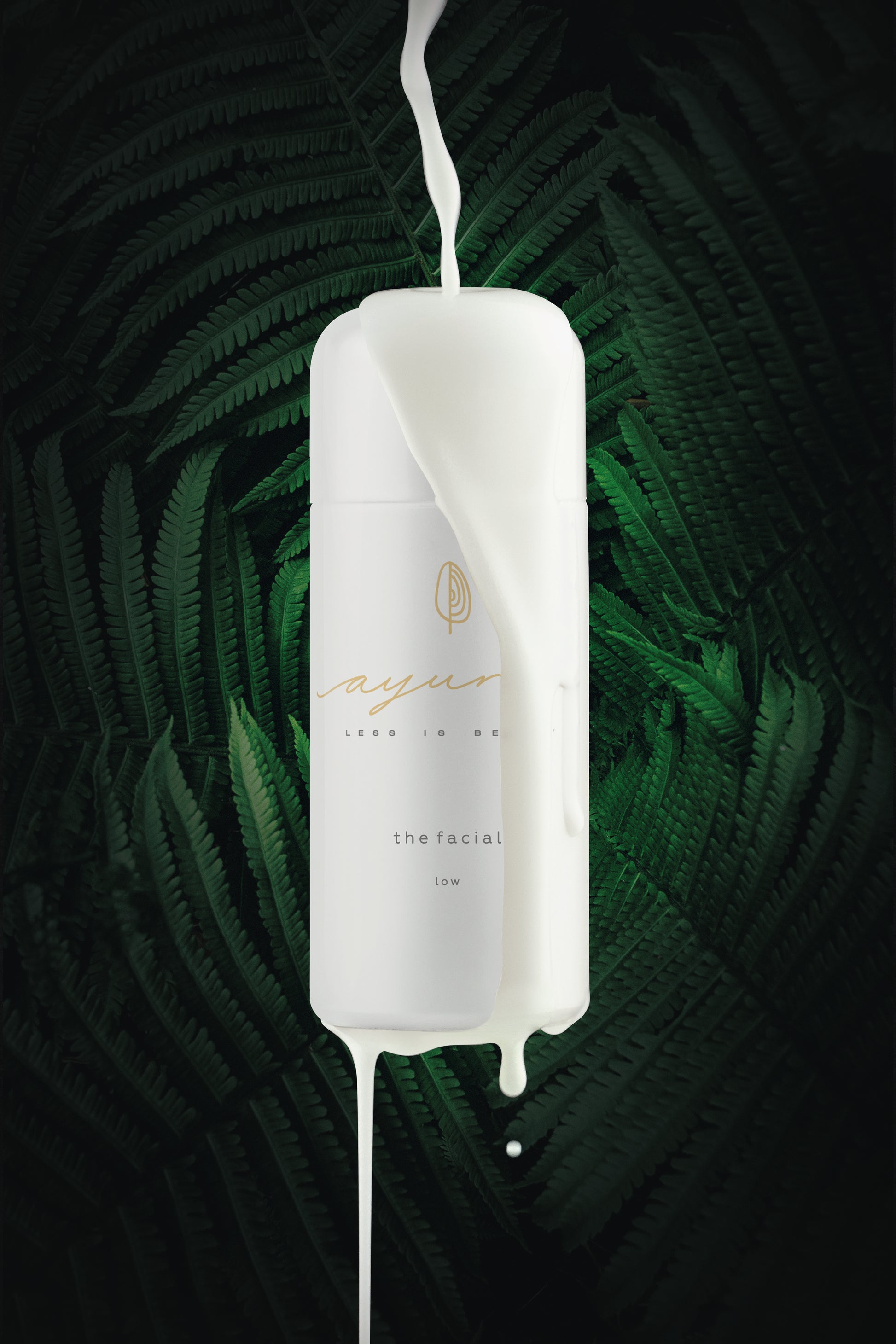 White bottle of ayuna the facial - low with green leafy background
