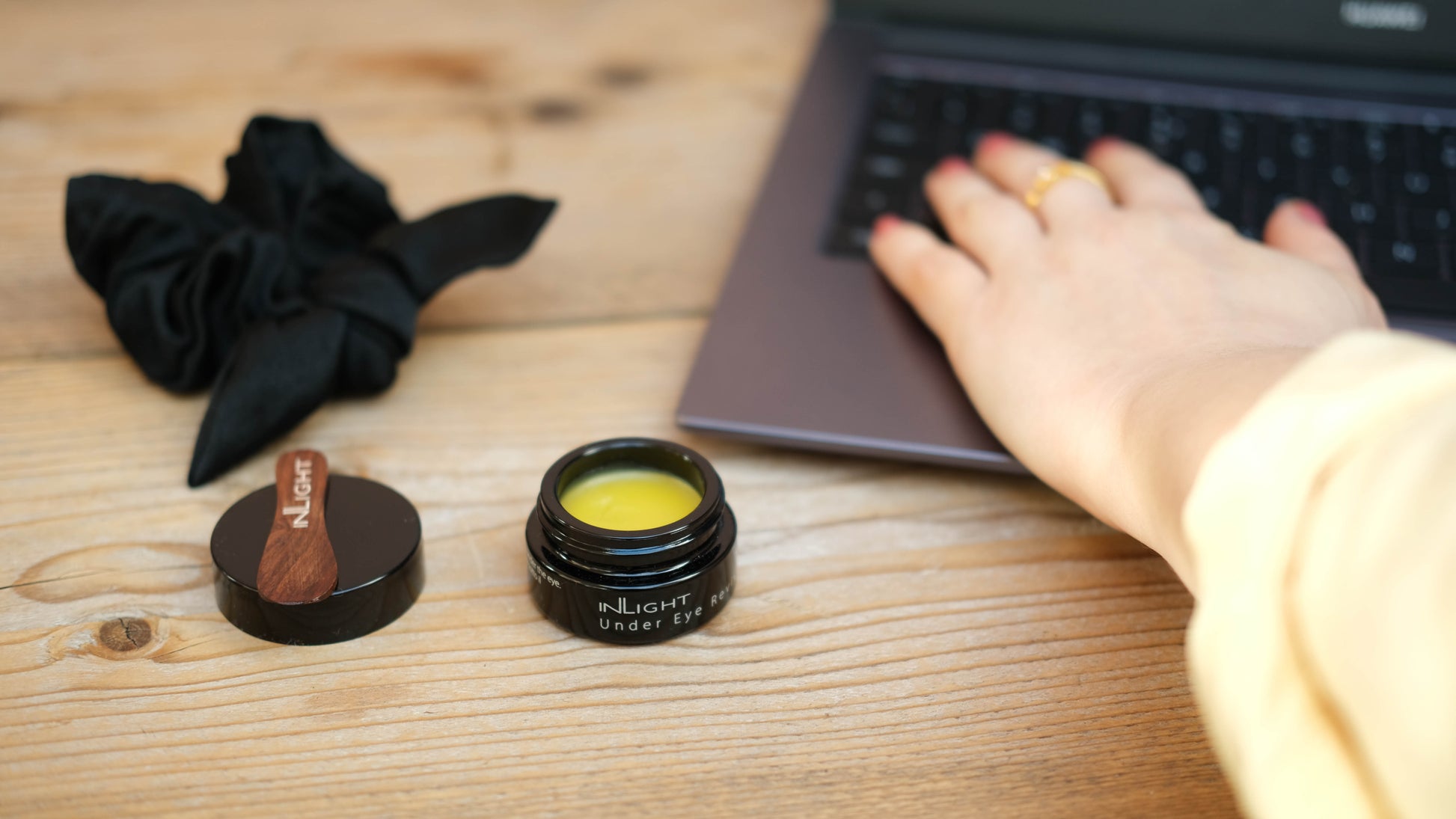 An open jar of the inlight under eye revive on a desk