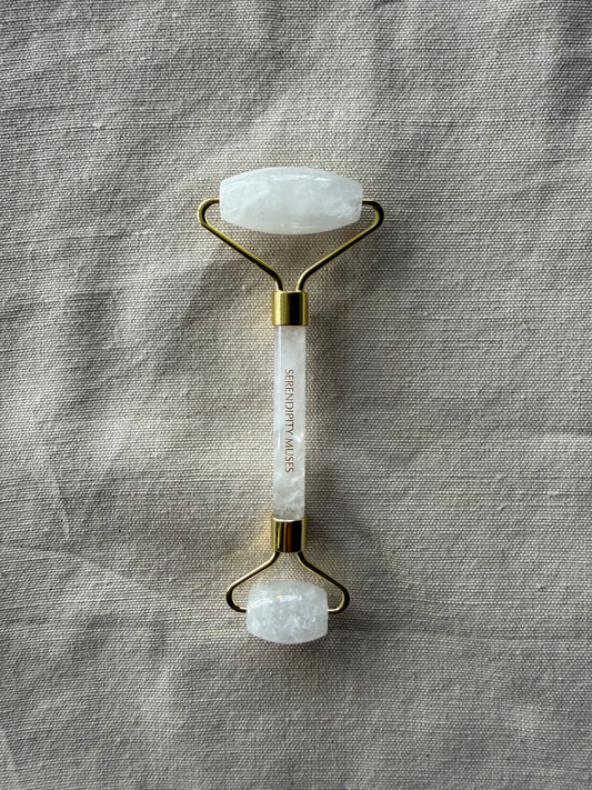 White Jade Facial Roller with gold Serendipity Muses logo on a white background