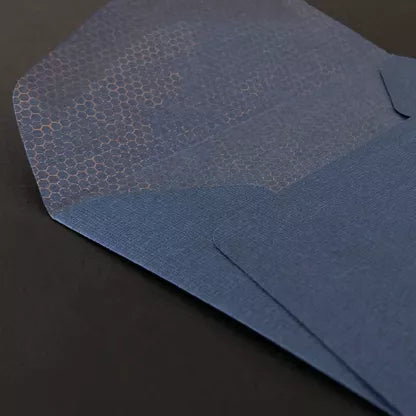 Close-up of an open blue envelope on a dark surface