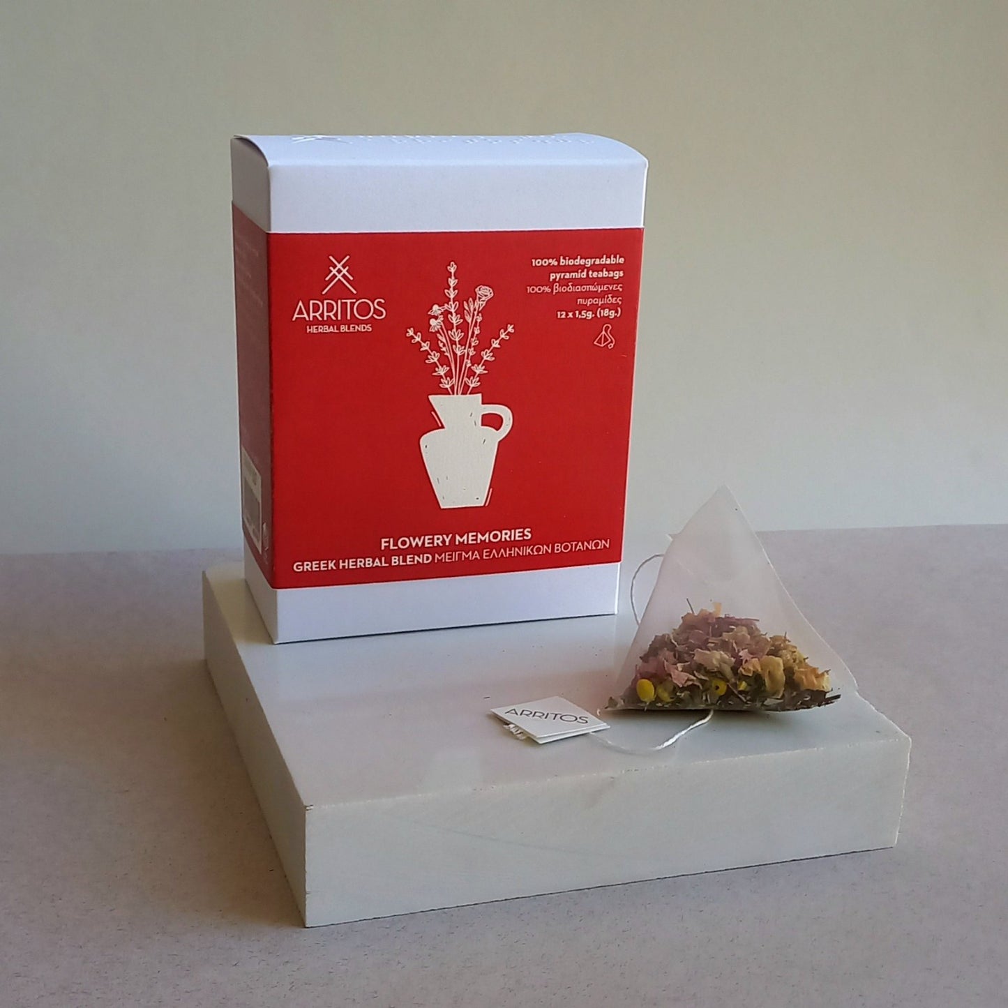 a box and a tea bag of Flowery Memories herbal blend by Arritos
