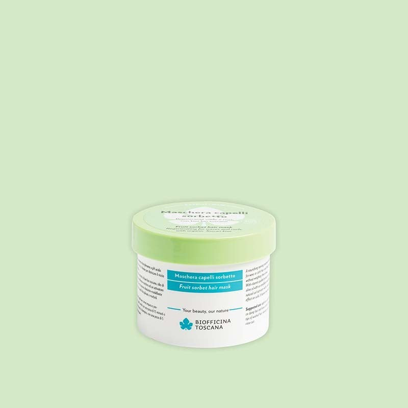 Jar of fruit sorbet hair mask by Biofficina Toscana with a green background
