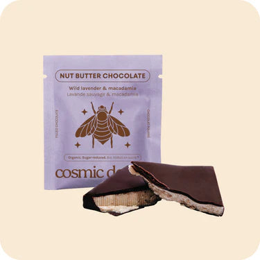 Cosmic Dealer Nut Butter Chocolate packaging with a pink label on a beige background Wild Lavender & Macadamia