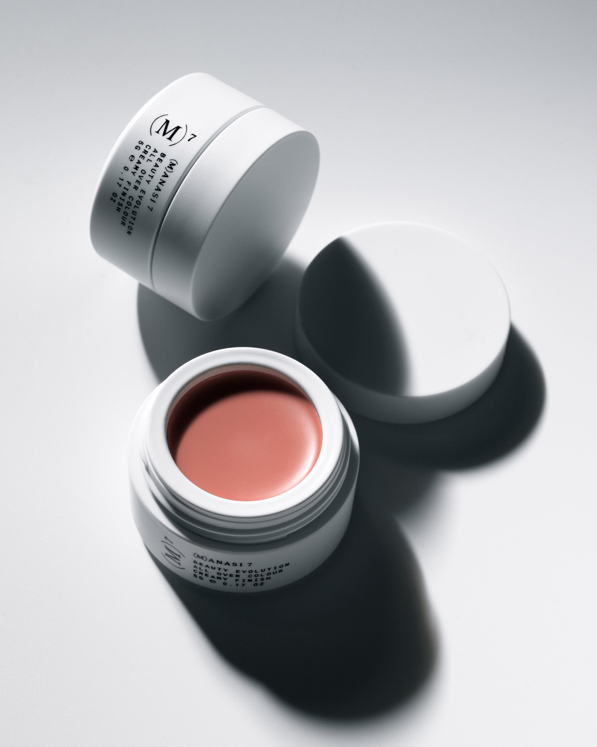 Two Manasi 7 Bisque All over Colour in a white containers on a white background