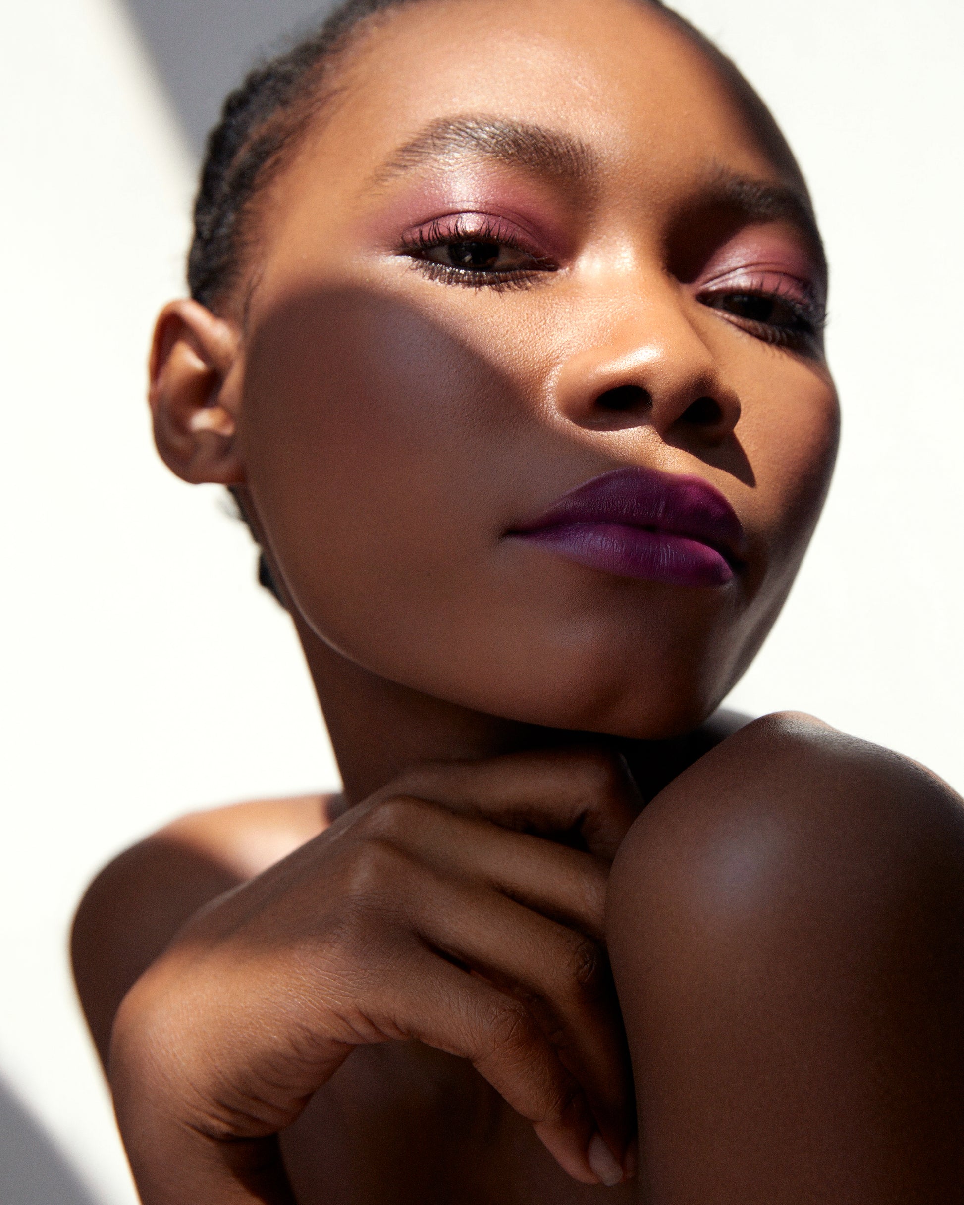 Close-up of a woman wearing the Manasi 7 Dianthus All over Colour on her eyes, lips and cheeks with a neutral background