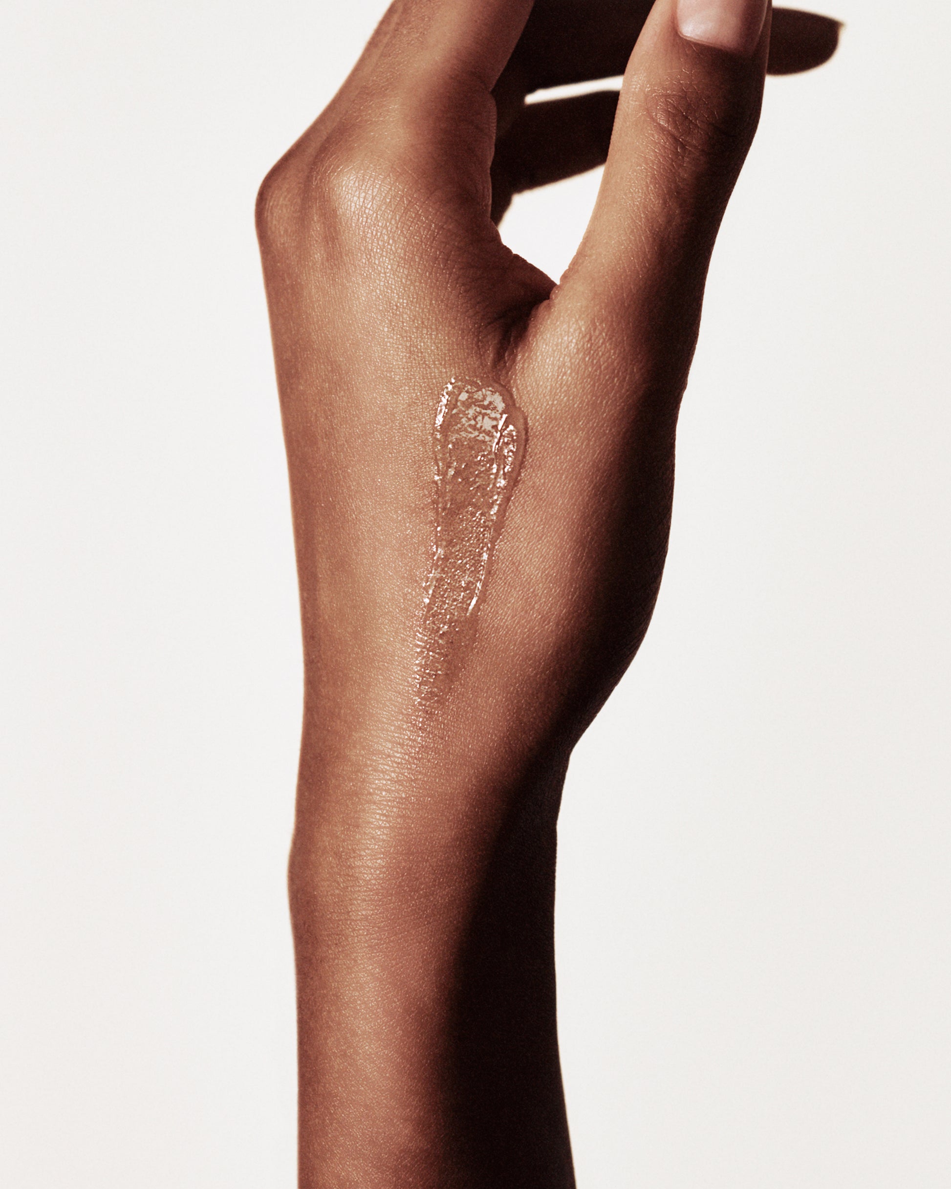 Hand with a swatch of the Manasi 7 all over shine cristallo