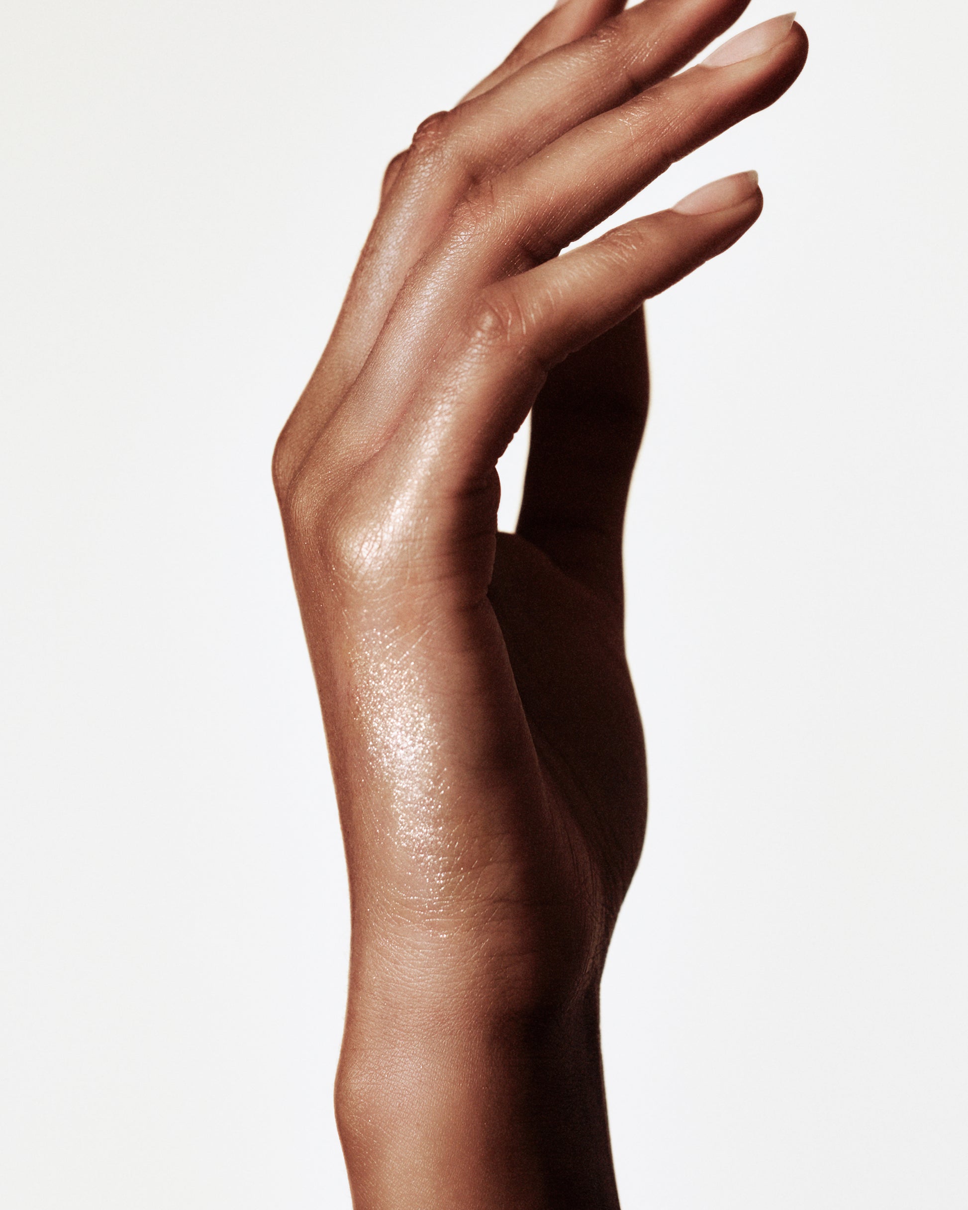 Hand with a swatch of the Manasi 7 all over shine kaito