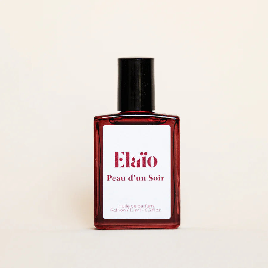 Perfume bottle labeled 'Elaïo Peau d'un Soir' on a beige background