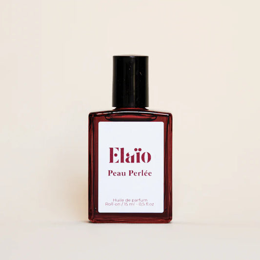 Elaéo Peau Perlée perfume bottle on a beige background