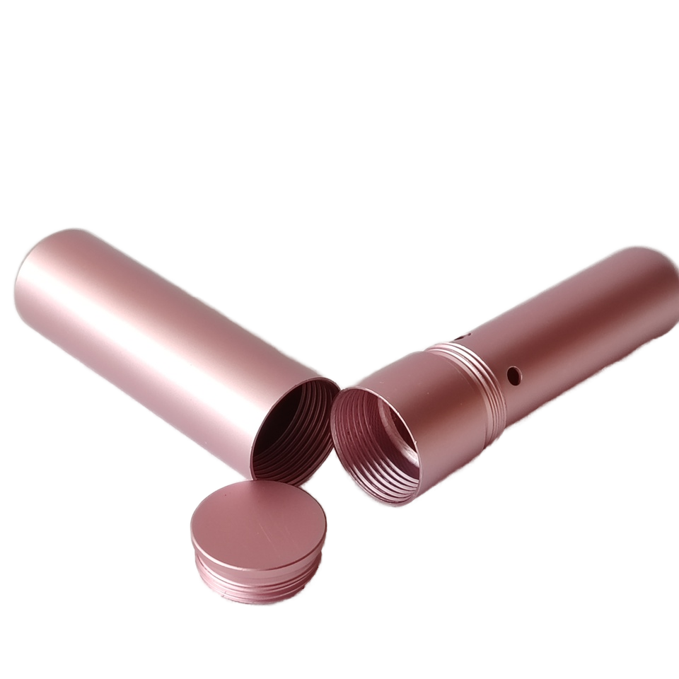 pink cylindrical nasal inhaler with a lid on a white background