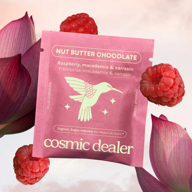 Pink package of 'Nut Butter Chocolate' with raspberries and pink flowers on a light pink background