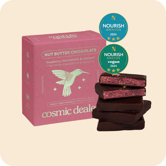 Box of Nut Butter Chocolate Raspberry  macadamia with 'Cosmic Dealer' branding and Nourish Awards badges on a beige background