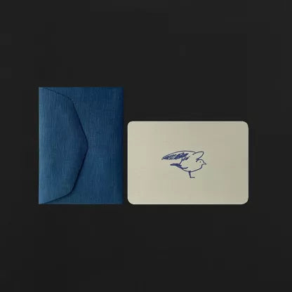 Blue envelope and white card with a blue bird design on a black background