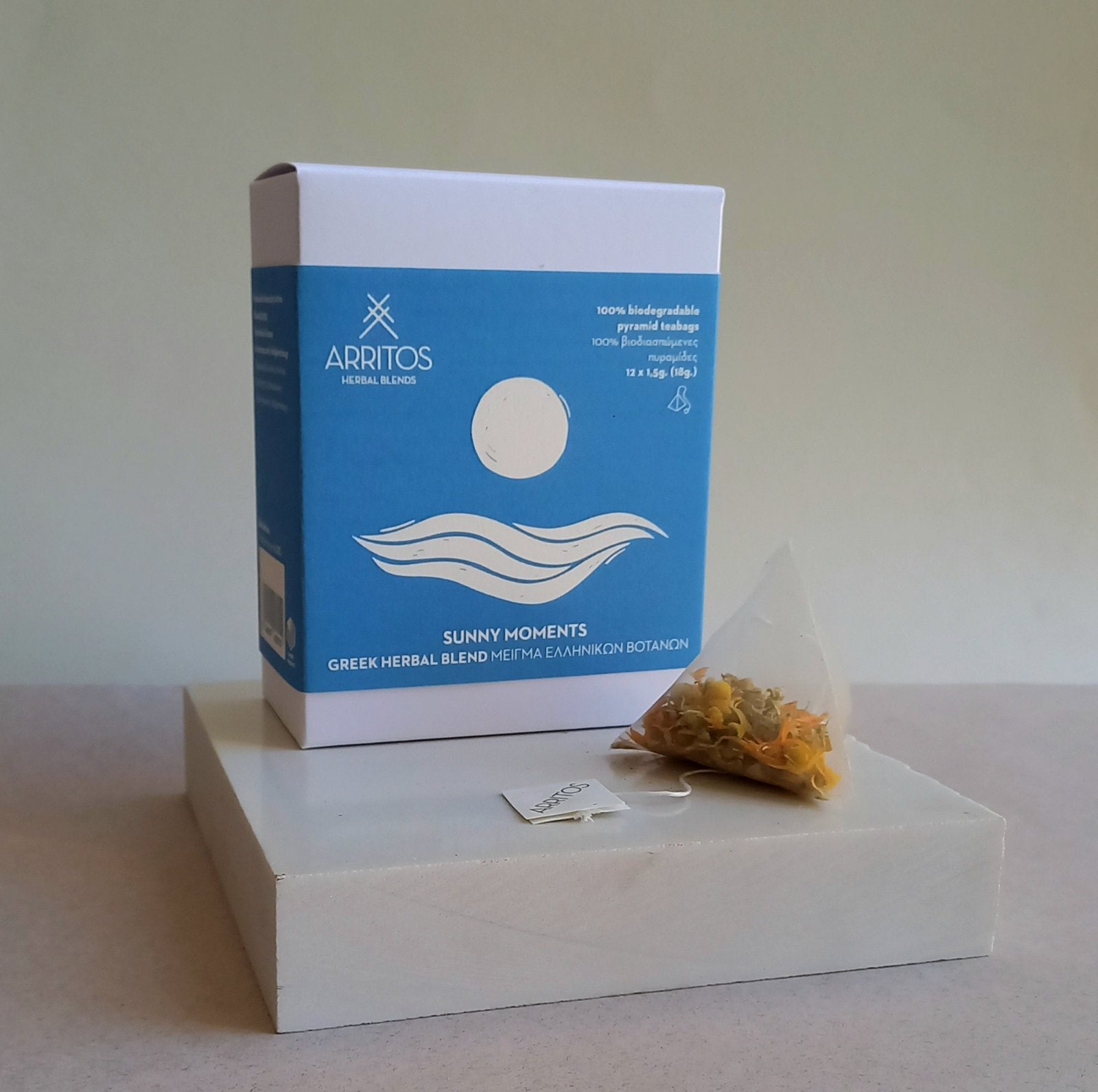 a box and a tea bag of Sunny Moments herbal blend by Arritos